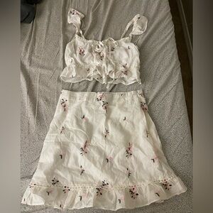 Raised by the wolves flower white set with top and skirt